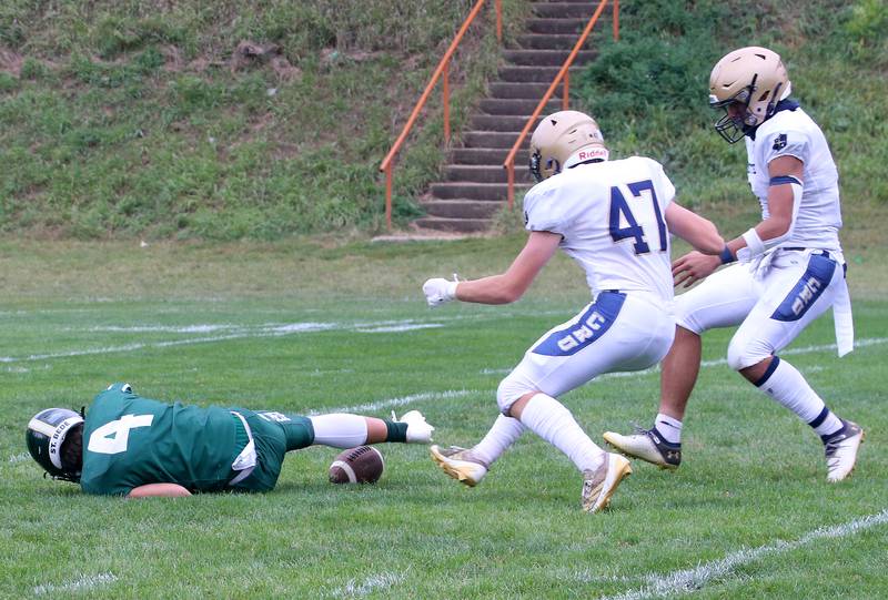 St. Bede quarterback AJ Hermes looses control of a snap as Marquette's Keaton Davis and Blayden Cassel picks up the fumble during the Homecoming game on Saturday, Sept. 28, 2024 at St. Bede Academy.