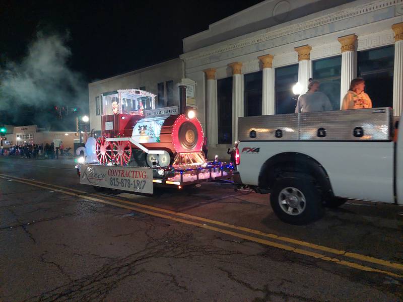 Keeney Contracting of Ladd participates in the Lighted Christmas Parade on Saturday, Dec. 2, 2023, in Peru with the Sno Globe Express, featuring Mickey Mouse.