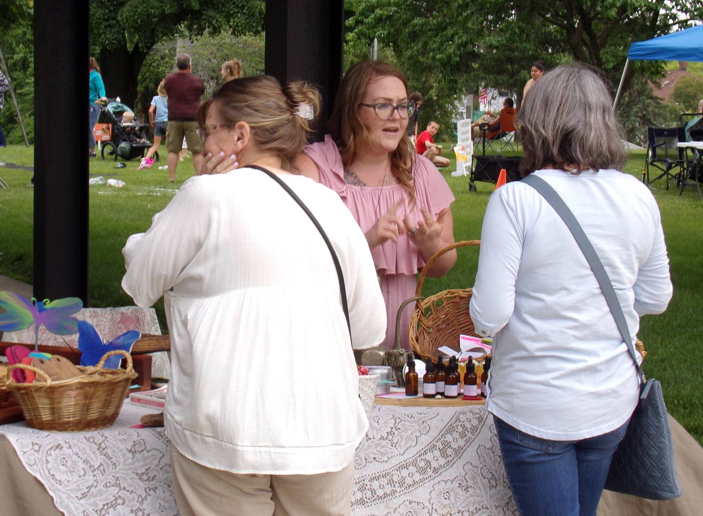 Customers ask questions at Just Ask Jasmine, an artist vendor Saturday, June 4, 2022, at the La Salle Music and Art Festival in Pulaski Park.