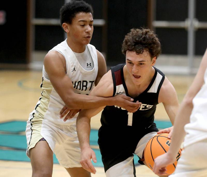 Prairie Ridge's Luke Vanderwiel (right) drives the lane against Grayslake North's Will Foley during the 2025 Hoops for Healing tournament basketball game on Wednesday, Nov. 26, 2025, at Woodstock North High School.