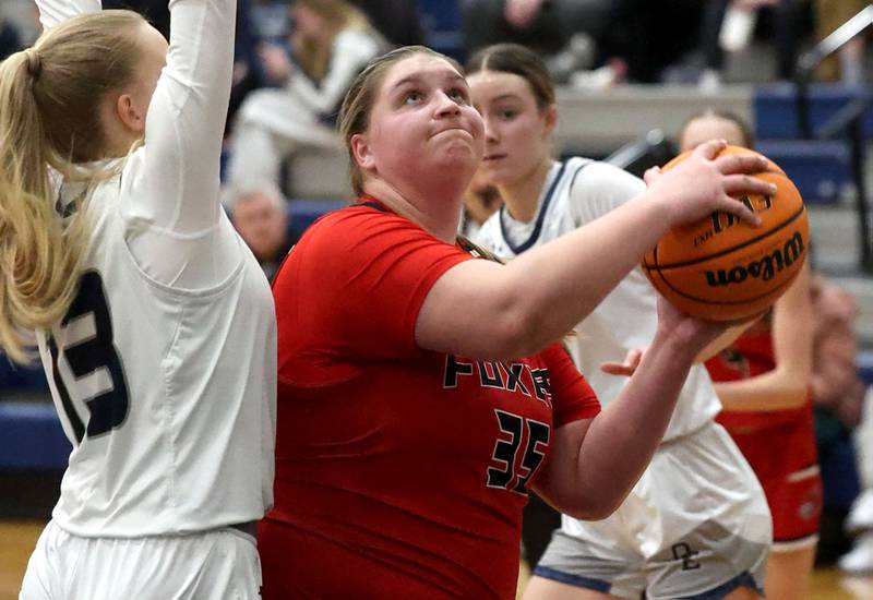 Yorkville's Madison Spychalski looks to score against Oswego East's Cassie Van Meter during their game Tuesday, Feb. 11, 2025, at Oswego East High School.