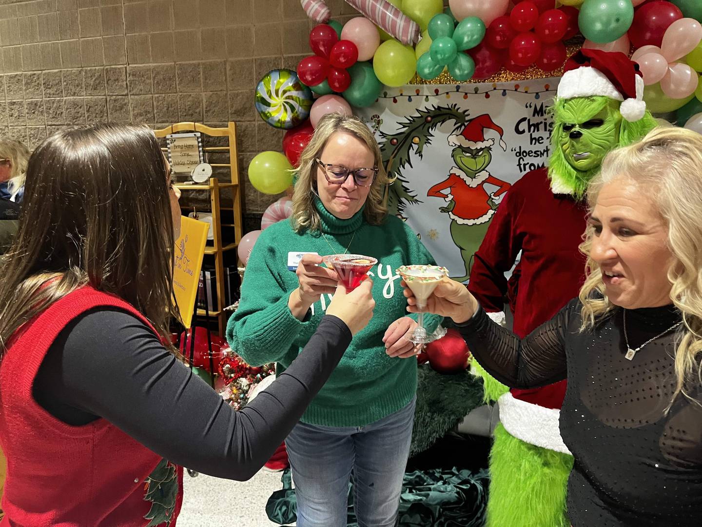 Chain O' Lakes chamber Executive Director Therese Matthys, center, shares a toast with (from left) Stephanie Grams of the Volo Museum and Kim Bromberek of Countryside Banquets as the Grinch looks on at the inaugural Mistletoe & Martinis in 2024. This year's event is Nov. 28.