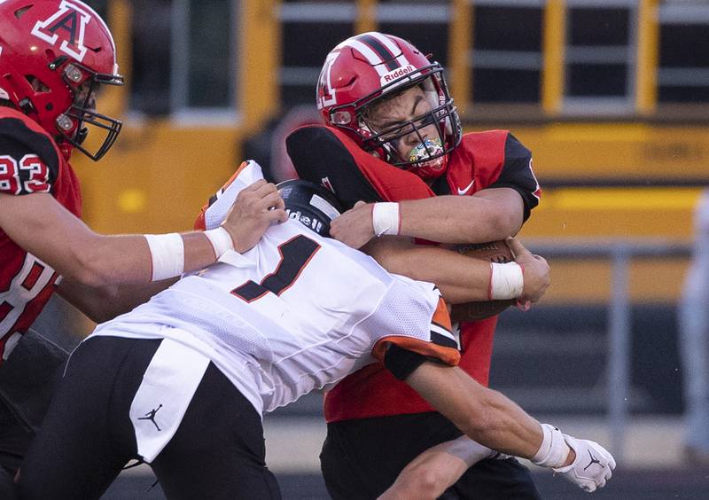 Amboy’s Jose Lopez is hit hard by Milledgeville’s Evan Schenck Friday, August 29, 2025, in Amboy.