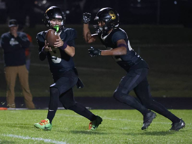 Sycamore's Griffin Larsen hands the ball off to Dylan Curtis during their game against La Salle-Peru Friday, Oct. 10, 2025, at Sycamore High School.