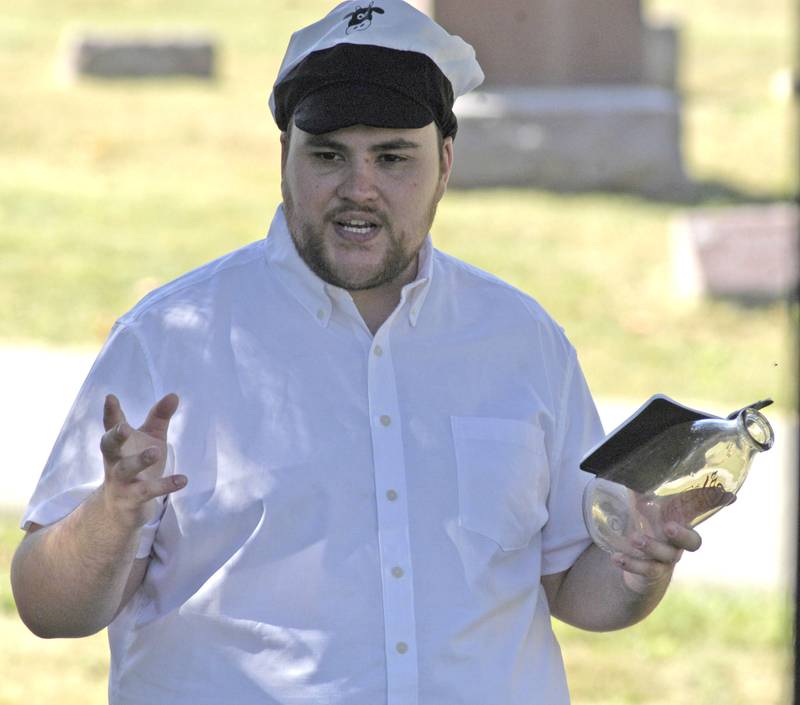Mathew Lenox, portraying Oscar Coss, founder of Coss Dairy, speaks to a group at the Lee County Historical and Genealogical Society's Cemetery Walk at Oakwood Cemetery in Dixon on Sunday, Sept. 28.