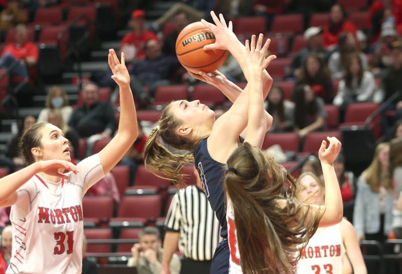 Nazareth's Olvia Austin splits two Morton defenders during their Class 3A state semifinal game Friday, March 4, 2022, in Redbird Arena at Illinois State University in Normal.