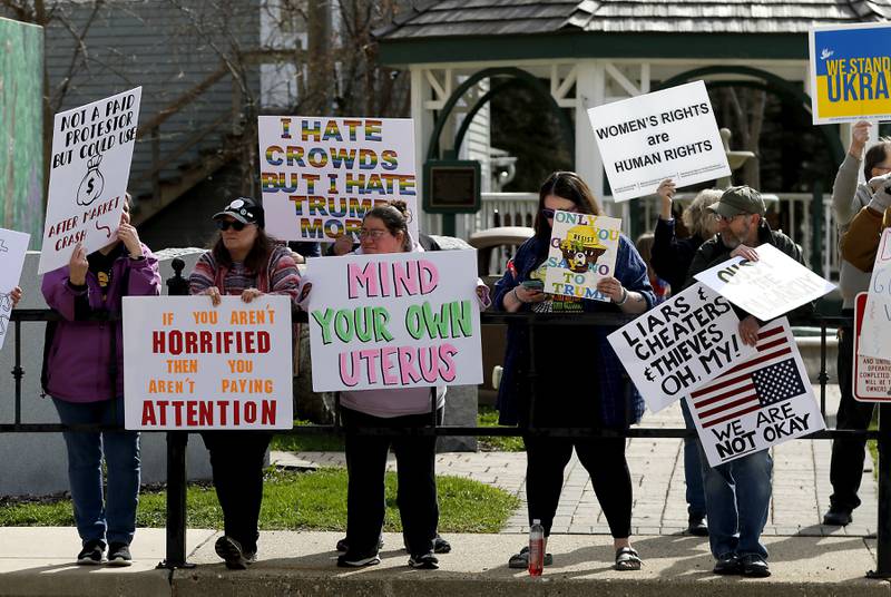Protesters line U.S. Route 12 in Richmond to protest their discontent with President Donald Trump and his administration's policies on Saturday, April 19, 2025. Over 100, people took part in the Richmond protest. A second rally was held in Harvard later in the day.