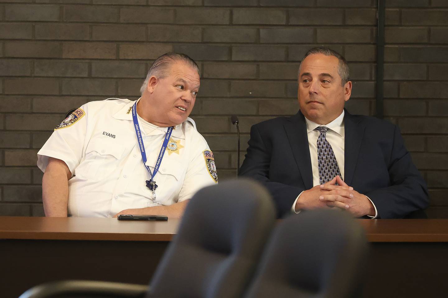 Joliet Police Chief William Evans talks with Joliet City Inspector General Stephen DiNolfo at a special hearing by the Joliet Board of Fire and Police Commissions on Wednesday, May 13, 2026 at Joliet City Hall. Evans recommended Joliet Police Lt. Jeremy Harrison's termination following DiNolfo's investigation.