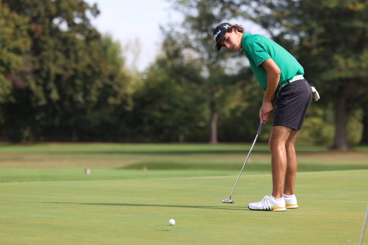 Bishop McNamara's Preston Payne watches a putt during the IHSA Class 1A Kankakee (McNamara) Regional at the Kankakee Elks Country Club on Wednesday, Oct. 1, 2025. Payne would finish in tied for third overall with a score of 82 to help the Fightin' Irish team claim the regional title for the first time since 2010.
