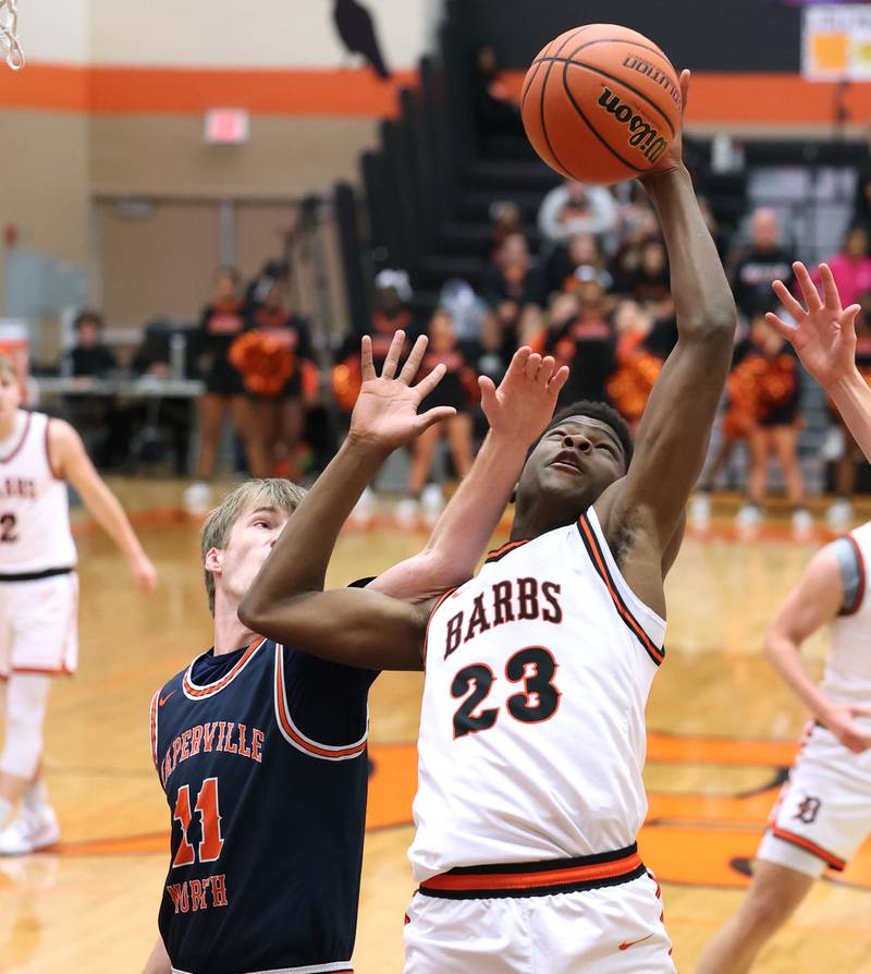 DeKalb’s Davon Grant grabs a rebound in front of Naperville North's Jack Kallstrand during their game Friday, Dec. 8, 2023, at DeKalb High School.