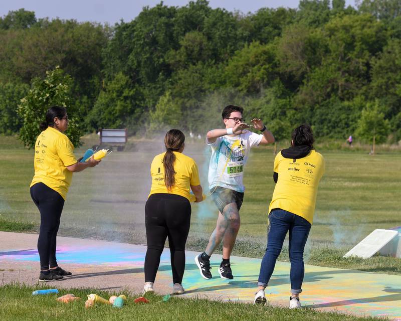 Diego Gonzalez of Sycamore get sprayed with color powder while running through a color stationon Saturday, June 7, 2025, during the CASA DeKalb County 5K Color Run held at the Sycamore Middle School.