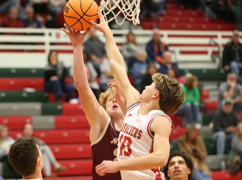L-P's Braylin Bond blocks Morris's RJ Kennedy's shot on Friday, Dec. 6, 2024 in Sellett Gymnasium at L-P High School.