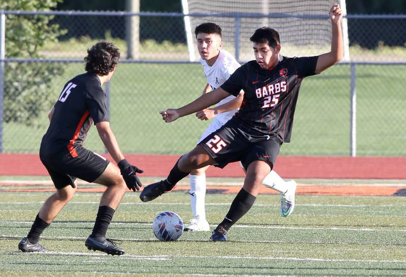 DeKalb's Josh De Los Santos looks to pass the ball to Aaron Tierney during their game against Auburn Thursday, Sept. 22, 2022, at DeKalb High School.