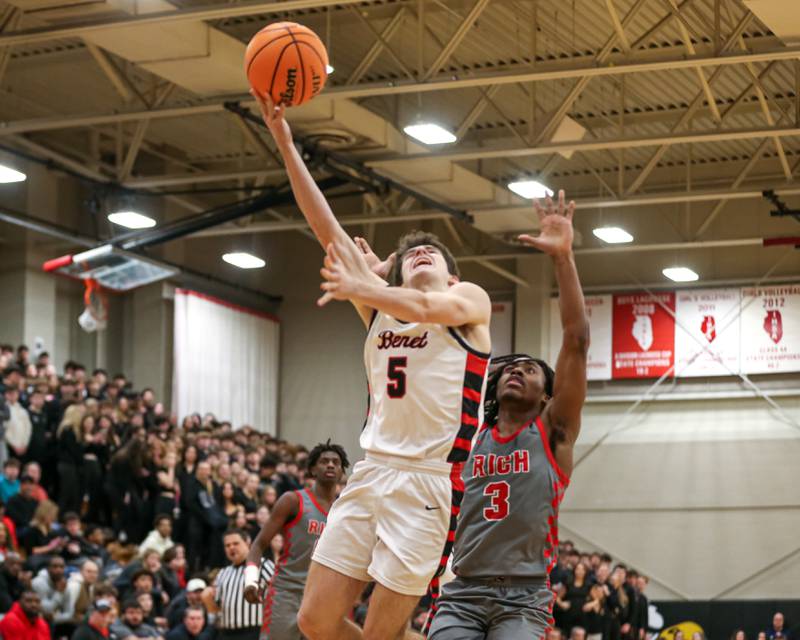 Benet's Michael Doyle (5) puts up a contested shot a the rim during their When Sides Collide Shootout basketball tournament matchup between Rich Township at Benet Academy. Jan 25, 2025 in Lisle.