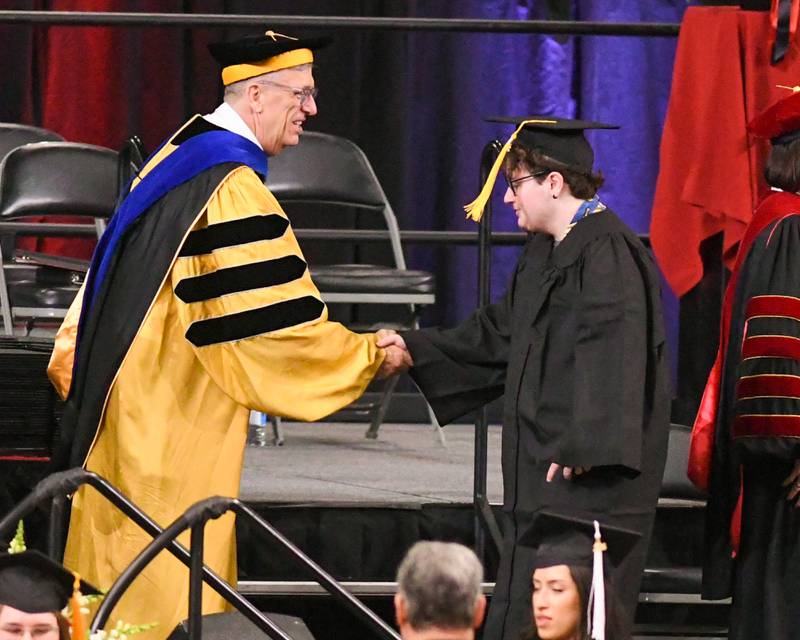 A Northern Illinois University is all smiles as he receiving her diploma on Saturday May 9, 2026, held at the Convocation Center in DeKalb.