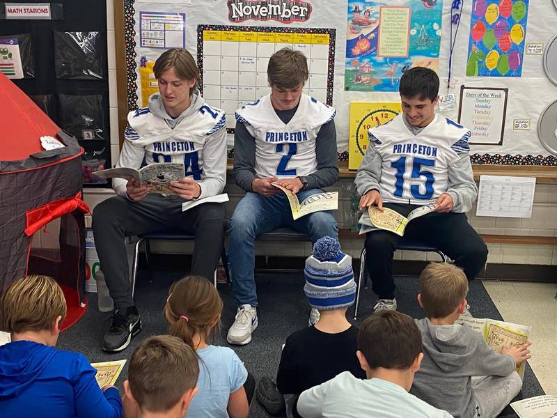 Princeton High School football players Danny Cihocki (left), Teegan Davis and Augie Christiansen read to second-grade students at Jefferson School on Monday afternoon as part of the “2nd and 7 Reading Initiative program." It is the first program started in Illinois.