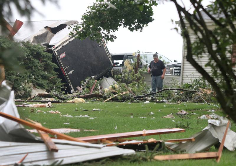 A trailer is tipped against a barn and debris litters the yard of a home on Fenstermaker Road in Sycamore Monday Aug. 9, 2021, after severe weather rolled through the area. Several funnel clouds and tornadoes were reported in DeKalb County Monday afternoon.