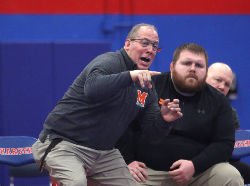 McHenry’s head coach Dan Rohman guides his team against Dundee-Crown in varsity wrestling at Carpentersville Thursday night.