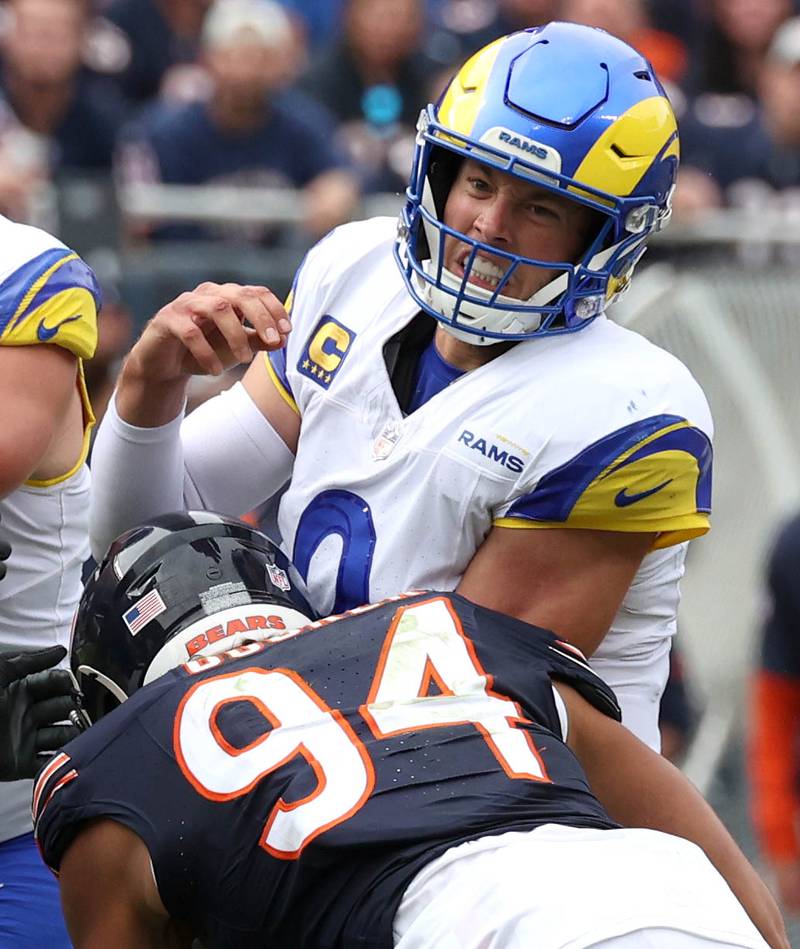 Los Angeles Rams quarterback Matthew Stafford takes a hit from Chicago Bears defensive end Austin Booker just after getting rid of the ball during their game Sunday, Sept. 29, 2024, at Soldier Field in Chicago.