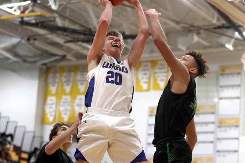 Lake Zurich’s Connor Strauss snags a rebound in Hinkle Holiday Classic boys basketball tournament game action at Jacobs High School Wednesday.