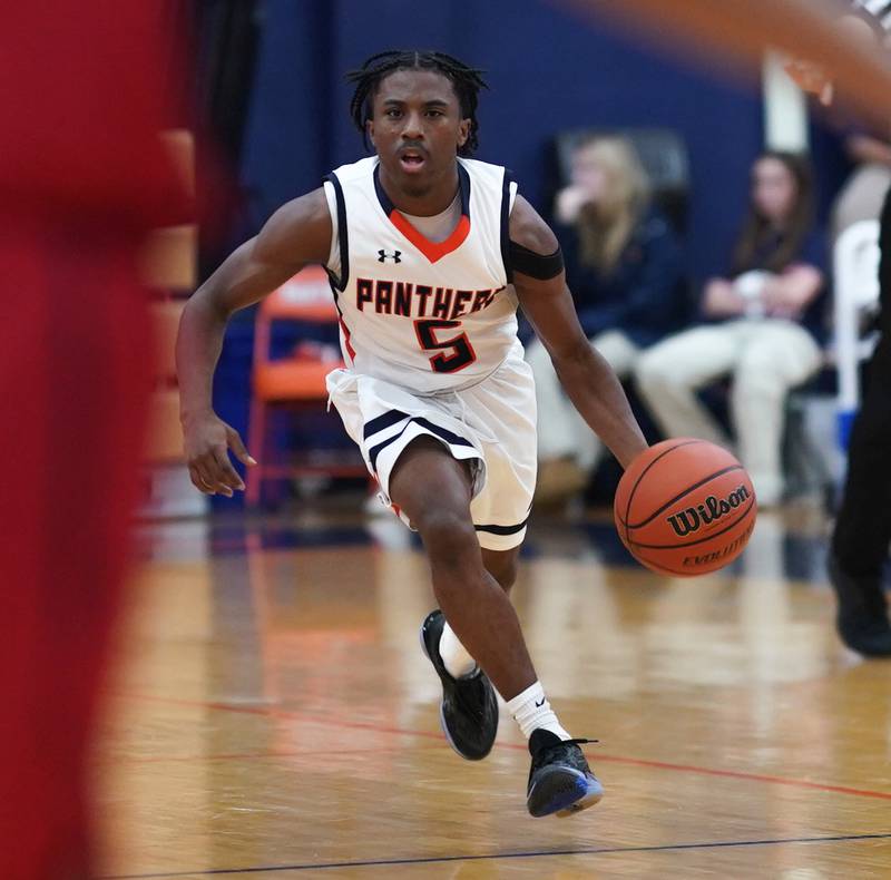 Oswego’s Tyrell Mays (5) brings the ball up court against West Aurora during a basketball game at Oswego High School on Friday, Dec 1, 2023.