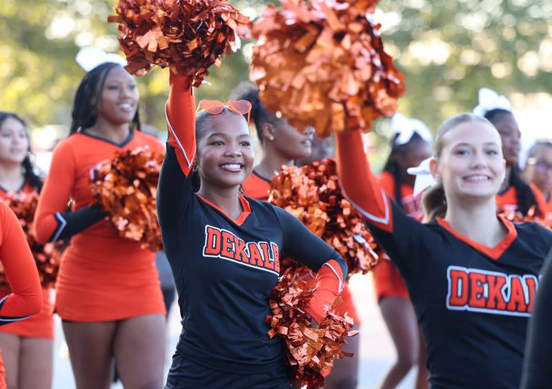 The DeKalb High School cheerleaders show their spirit as the head West Dresser Road Wednesday, Oct. 2, 2024, during the DeKalb homecoming parade.