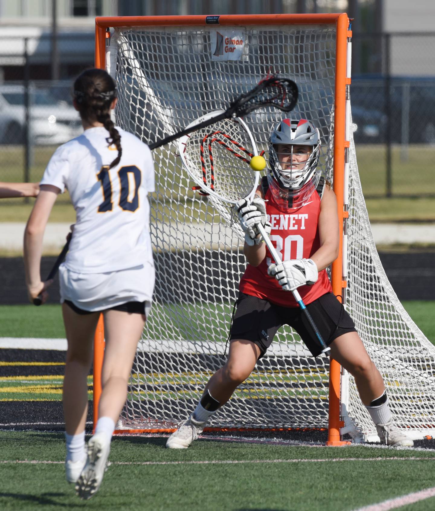 Benet Academy goalie Madeline Jensen saves a shot by Glenbrook South's Katie McGurn during the girls lacrosse state semifinal at Glenbrook North High School in Northbrook Thursday.