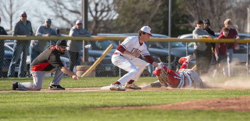 Yorkville's Owen Ross (14) avoids the tag while sliding into third base against Plainfield North's Mj Ansari (18) during a baseball game at Plainfield North High School on Thursday, April 21, 2022.