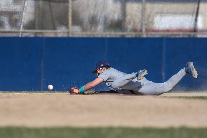 Plainfield South's Pablo Herrera (10) dives for a shot down the line during baseball game between Plainfield South at Oswego on Monday, April 14, 2025 in Oswego.