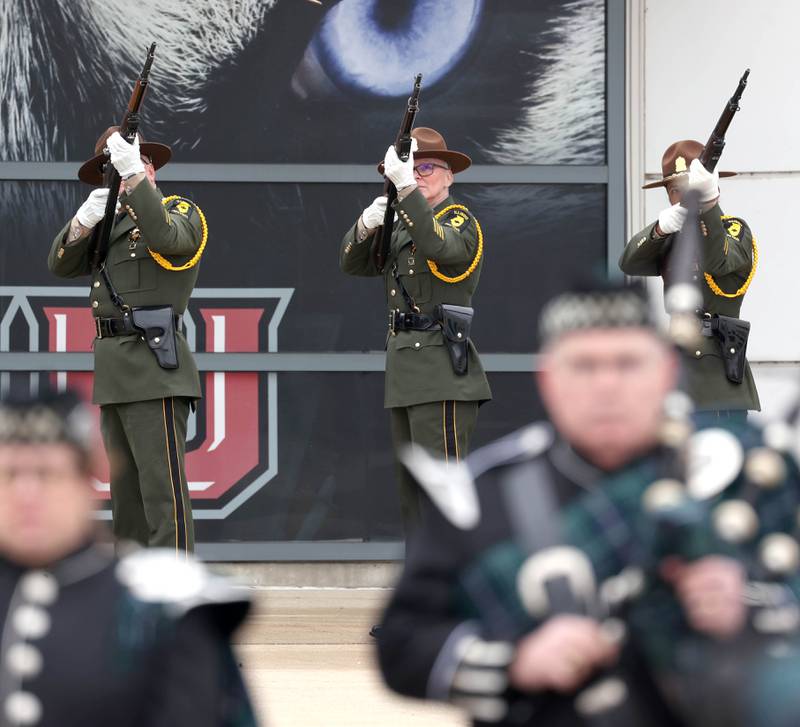 Illinois State Police officers fire a gun salute Thursday, April 4, 2024, outside the Convocation Center at Northern Illinois University, following the visitation and funeral for DeKalb County Sheriff’s Deputy Christina Musil. Musil, 35, was killed March 28 while on duty after a truck rear-ended her police vehicle in Waterman.