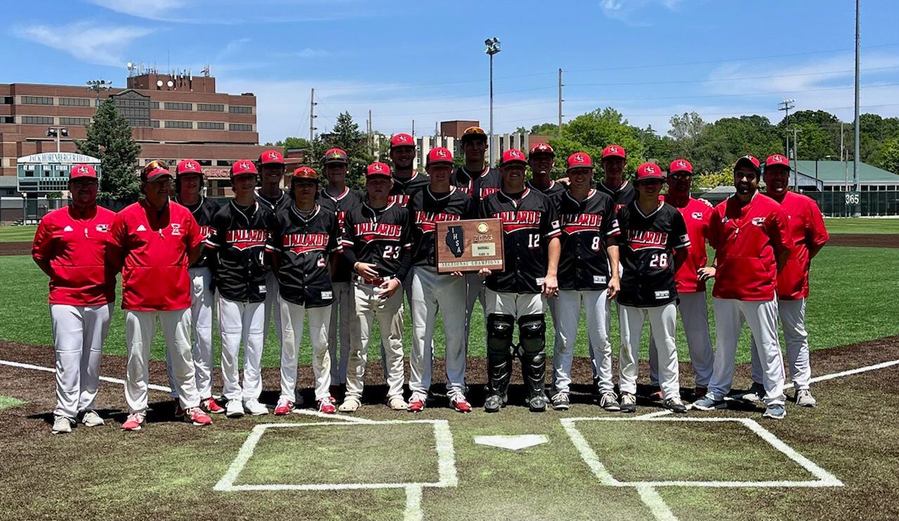 The Henry-Senachwine baseball team poses with its plaque after defeating Milford 6-1 in the Class 1A Illinois Wesleyan University Sectional championship Saturday in Bloomington.