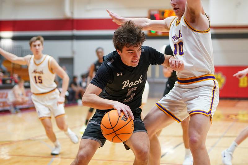 Oswego East's Josh Lopez (5) posts up against Downers Grove North's Bobby Grganto (10) during a Batavia Night of Hoops Basketball game at Batavia High School on Saturday, Jan. 25, 2025.