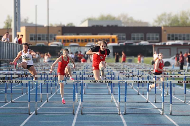 Bradley-Bourbonnais' Meara Pizur, center, clears the final hurdle to take first place in the girls 100-meter hurdles during the All-City meet at Kankakee High School on Monday, April, 28, 2025.