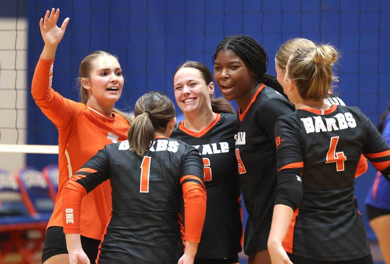 DeKalb players celebrate a point Wednesday, Sept. 11, 2024, during their game at Genoa-Kingston High School.