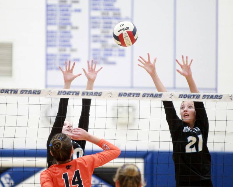 St. Charles North's Brianna Dale (20) and St. Charles North's Brynn Hopkins (21) block a shot from Oswego’s Mia Jurkovic (14) during a game Wednesday, Sept. 18, 2024 at St. Charles North.