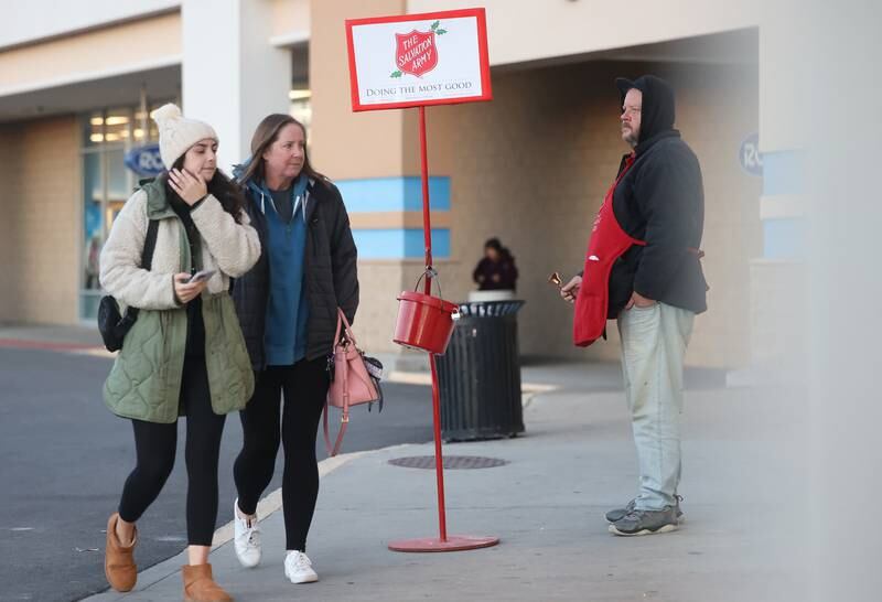 A volunteer rings the bell for the Salvation Army as customers enter Hobby Lobby on Wednesday, Nov. 29, 2023 in Joliet.