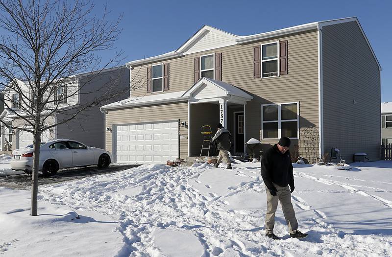 Woodstock police officers look for evidence the morning of Tuesday, Jan. 25, 2022, after a shooting Monday evening, outside a home in the 1700 block of Yasgur Drive in Woodstock.