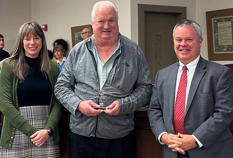 The Bike Rack received a 'Made in St. Charles Award' on Nov. 17, 2025. Pictured, Executive director of the St. Charles Business Alliance Jenna Sawicki, The Bike Rack Owner Hal Honeyman,  and Mayor Clint Hull.