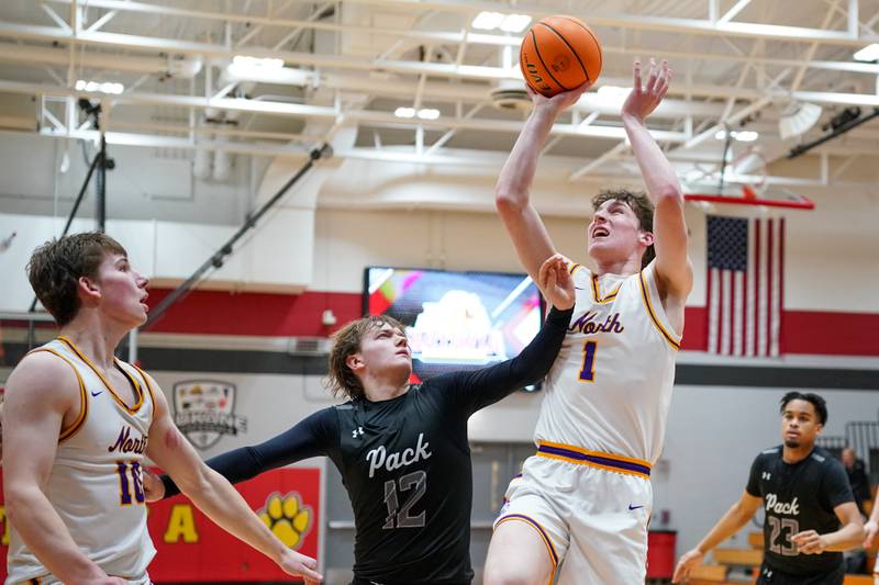 Downers Grove North's Colin Doyle (1) shoots the ball in the paint over Oswego East's Lukas Adolfs (12) during a Batavia Night of Hoops Basketball game at Batavia High School on Saturday, Jan. 25, 2025.