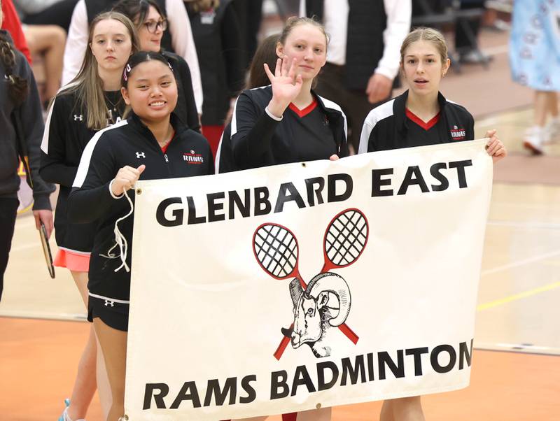 Members of the Glenbard East badminton team wave to their fans during the parade of teams Friday, May 10, 2024, prior to the IHSA State Badminton Finals at DeKalb High School.