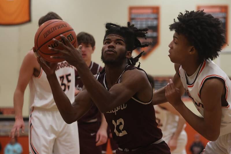 Lockport’s Jalen Falcon works under the basket against Minooka.