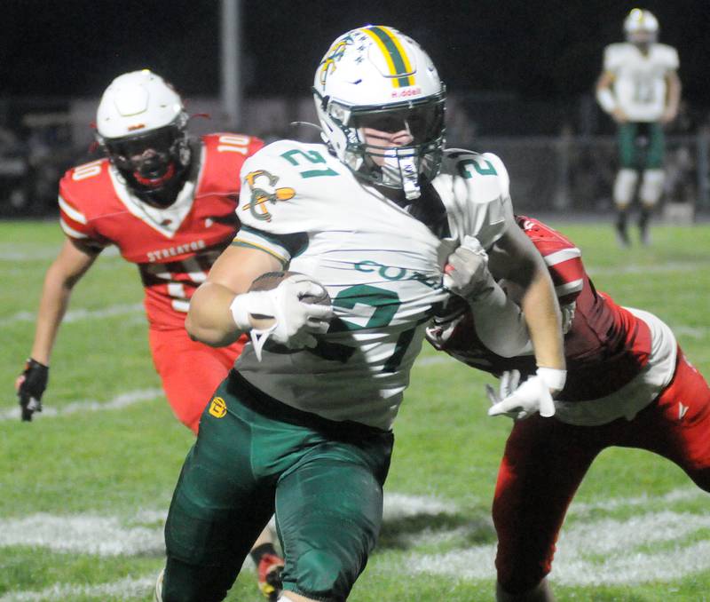 Coal City's Logan Natyshok (21) squeezes past Streator defenders Jon Davis (10) and Aiiden Wilkinson on Friday, Sept. 19, 2025 at Doug Dieken Stadium.