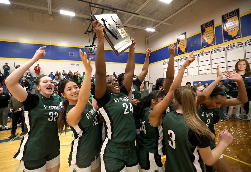 St. Edward's Sanaii McPherson lifts the trophy as she celebrates defeating Johnsburg in  the IHSA Class 2A Johnsburg Sectional girls basketball championship game on Thursday, February, 26, 2026, at Johnsburg High School.