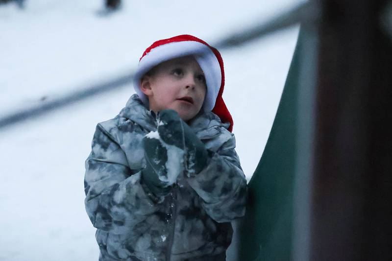 A child puts snow on a slide at Plainfield’s holiday kickoff Grinchmas on the Green on Saturday, Dec. 5, 2025 in Plainfield.