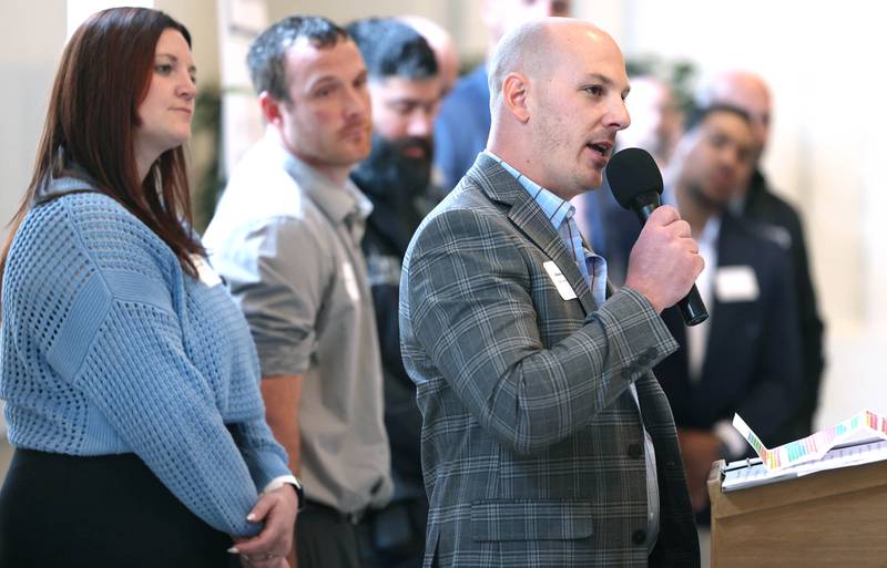 Chase Goodeill speaks as members of his staff listen along after their business Pest Control Consultants was presented the Spirit of Small Business Award during the 107th Annual Sycamore Chamber of Commerce Meeting Thursday, March 7, 2023, in Memorial Hall at St. Mary's Catholic Church in Sycamore.