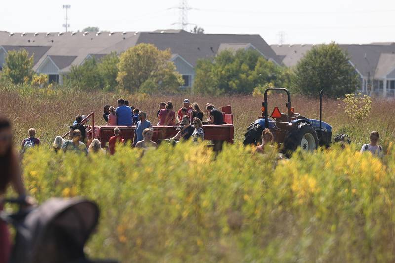 Event goers load up on a trail for a hay ride at the Autumn Family Fun Fest on Saturday, Sept. 23, 2023 in Plainfield.