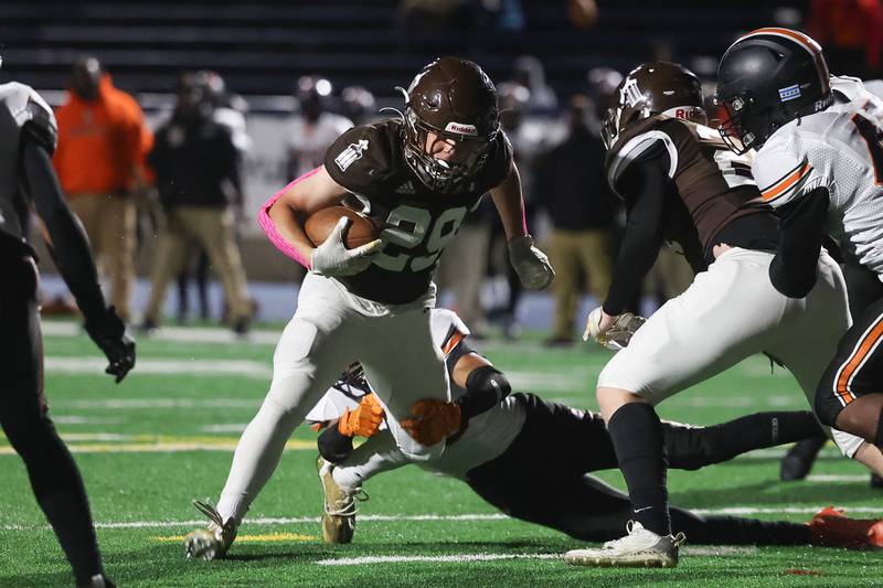 Joliet Catholic’s Keegan Farnaus sheds a tackler on a touchdown run against Leo on Friday, Oct. 6, 2023 in Joliet.