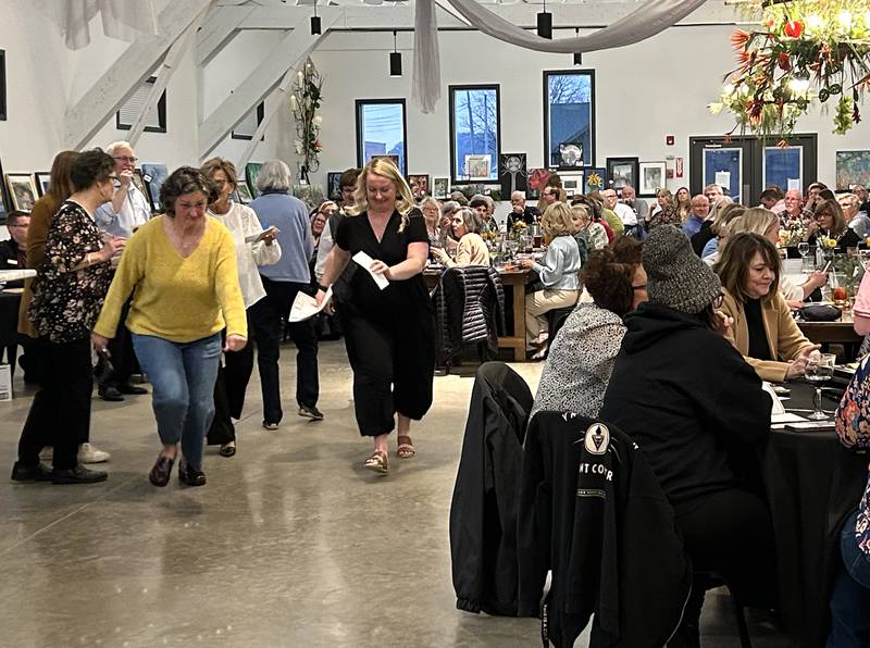 Kelsey Rogers (black attire) 'dashes' to her art choice during the Serenity Hospice and Home’s Fourth Annual Art Dash fundraiser on Wednesday, April 9, 2025, at River’s Edge Experience, 103 S. First St., Oregon.