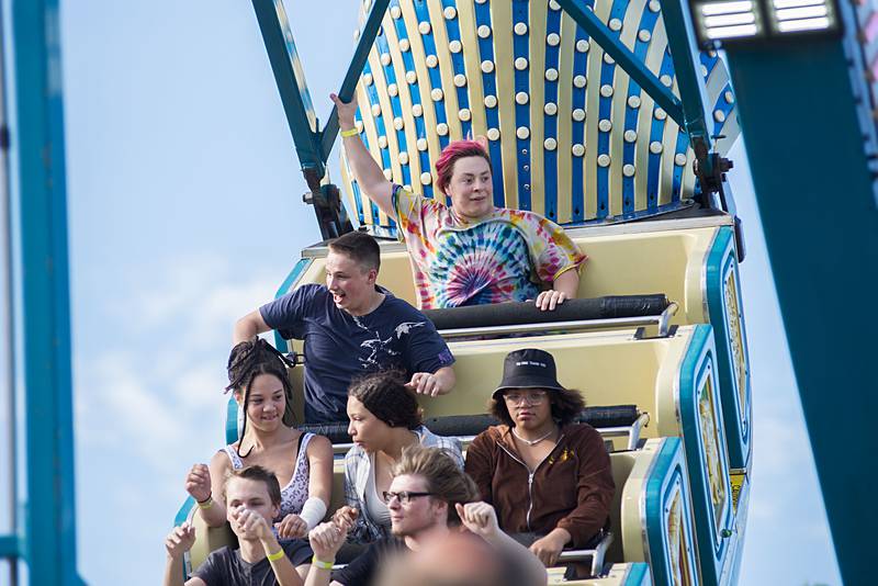 Gabriel Lugo (top) of Dixon raises an arm while riding the Pharaoh’s Fury during the opening day of the Petunia Fest carnival on Thursday, June 30, 2022.