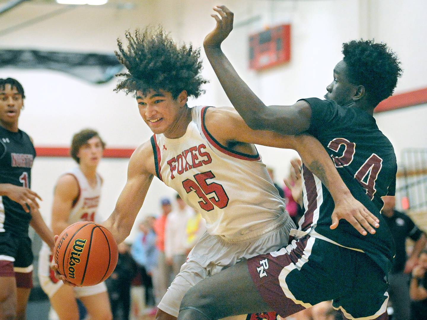 Yorkville's LaBaron Lee (35) drives to the basket against Plainfield North defender Shaibu Mohammed (24) during a boys’ varsity game at Yorkville High School on Tuesday, Nov. 29, 2022.